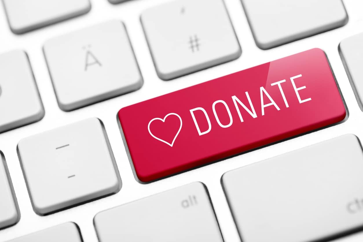 A red key on a computer keyboard that says “donate” to imply one should use it to donate to charity.
