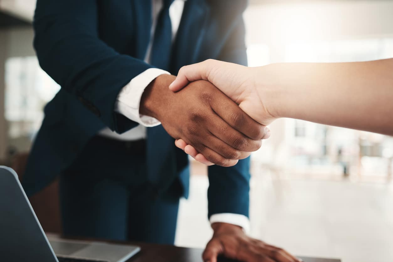 Handshake to represent conducting business at a Black-owned bank and a commitment to racial equality.