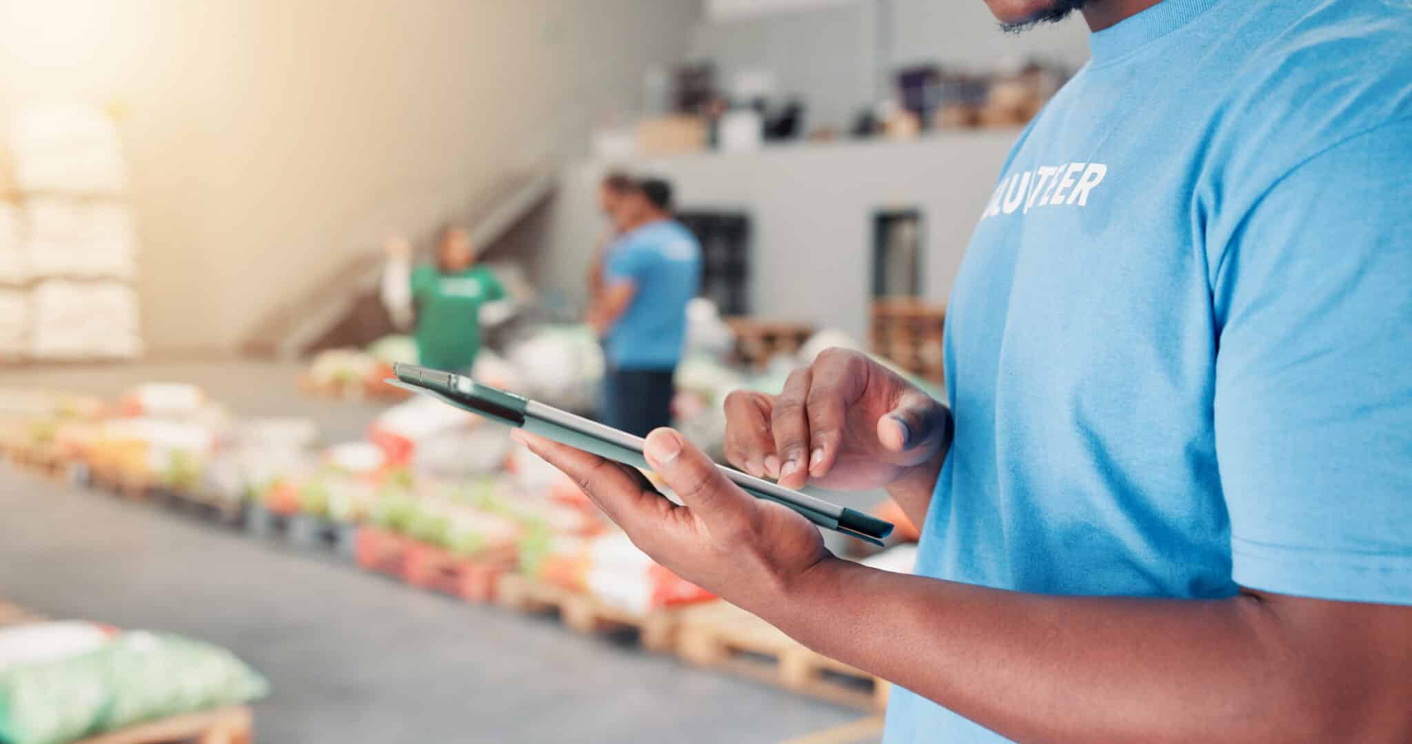 Volunteer using tablet for nonprofit banking support, financial services, and business banking tools.